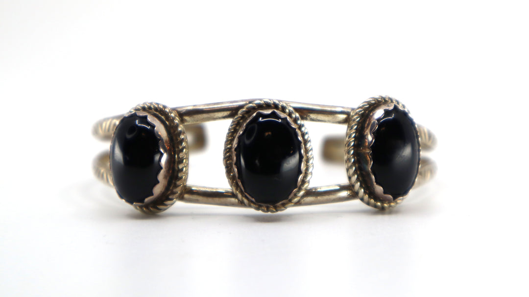 Handmade Navajo sterling silver cuff bracelet with onyx oval stones on Utah reservation