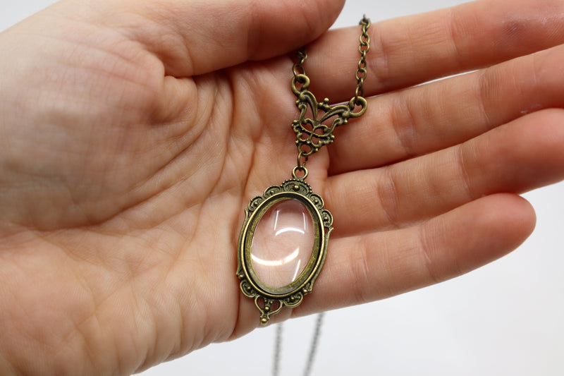 Gothic vintage magnifying glass pendant necklace with antique metal finish.