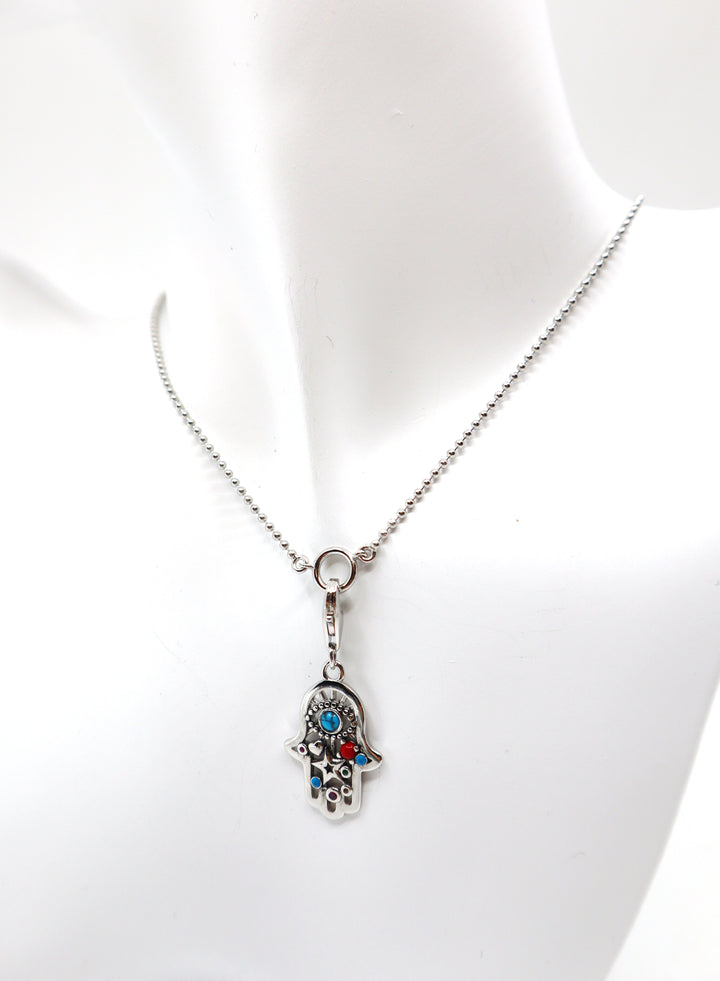 Sterling silver charm necklace with zircon gemstone on mannequin bust.