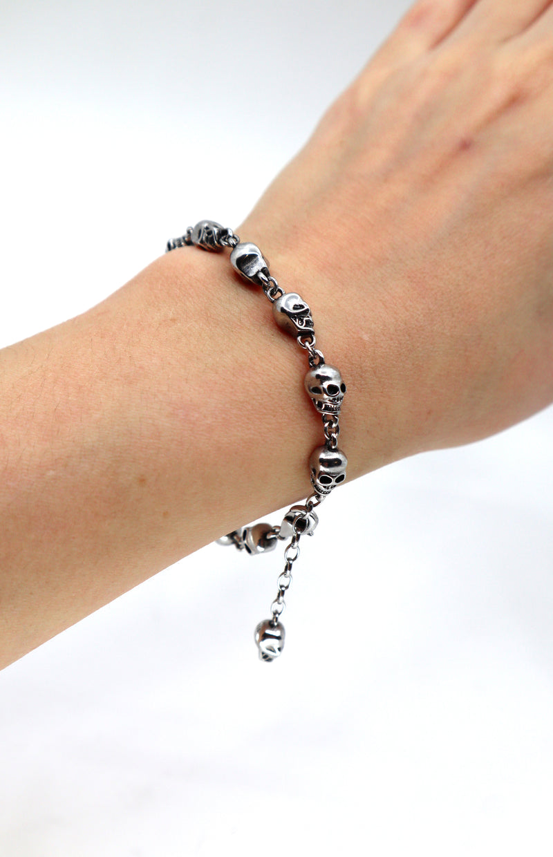 Skulls bracelet with detailed skeleton skulls in vintage street style on wrist