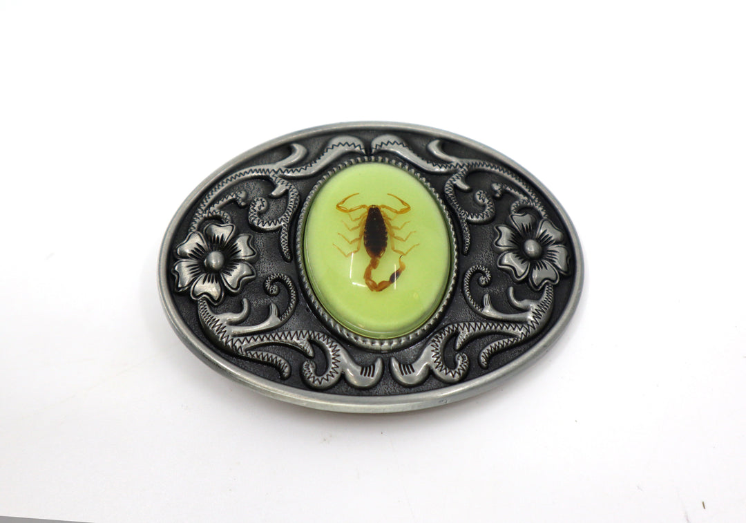 Silver alloy belt buckle with floral pattern and scorpion centerpiece.