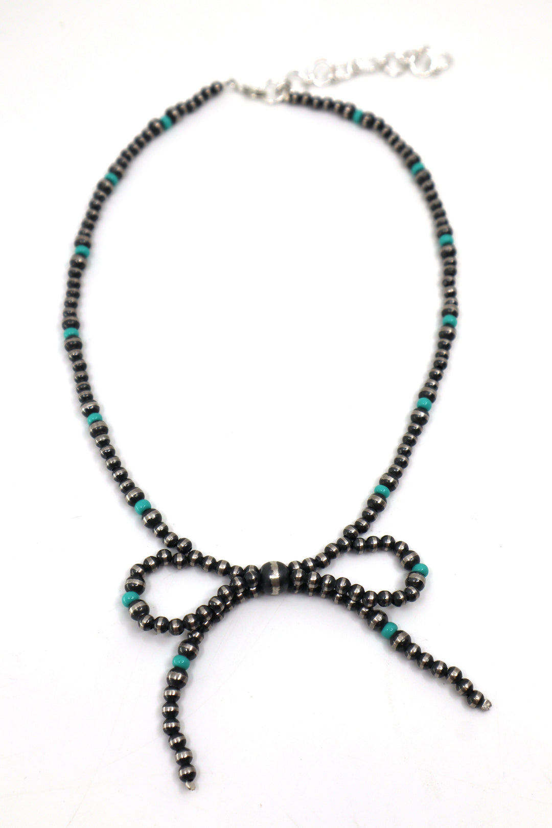 Handmade sterling silver necklace with pearl, turquoise beads, and bow design