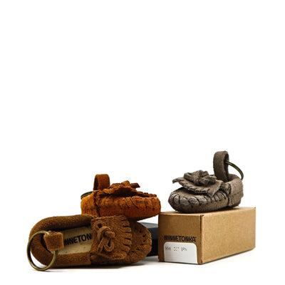 Minnetonka Key Ring featuring mini suede moccasin shoes in brown and gray with key rings and packaging box