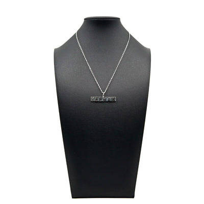 Handmade sterling silver Yeehaw necklace displayed on black stand