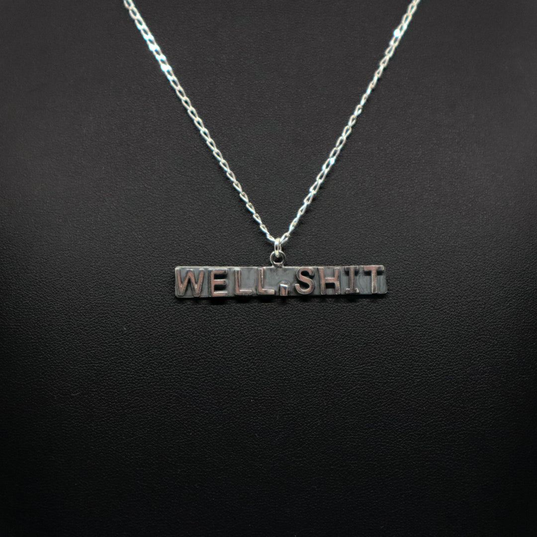Handmade sterling silver necklace with "WELL, SHIT" pendant on chain