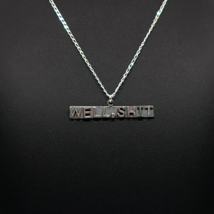 Handmade sterling silver necklace with "WELL, SHIT" pendant on chain