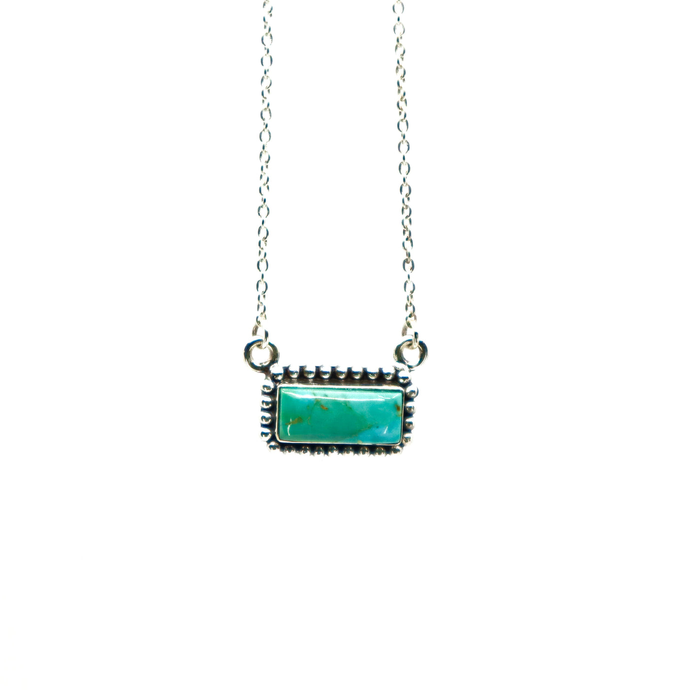 Sterling silver necklace with turquoise stone and intricate border design on small bar pendant