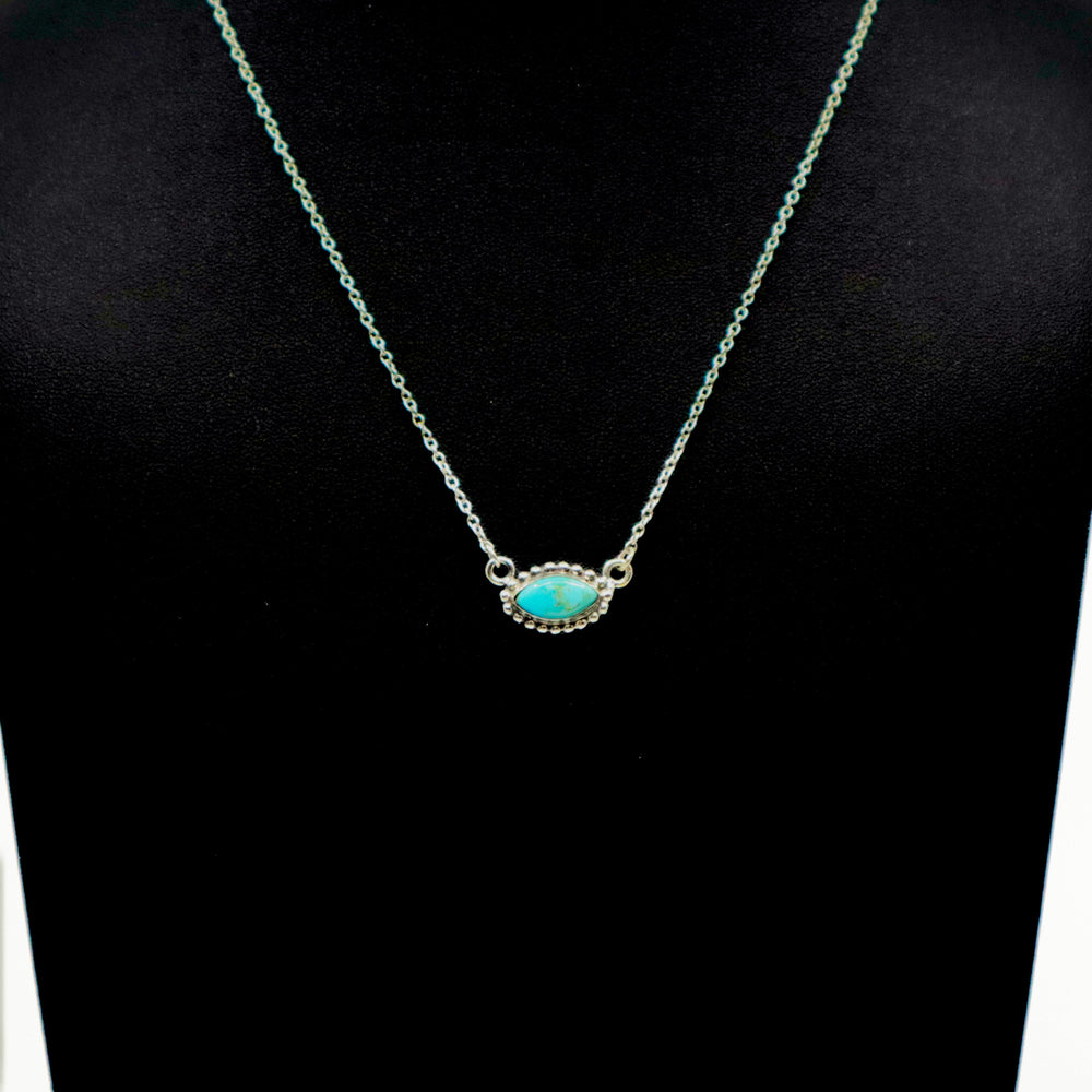 Handmade sterling silver necklace with turquoise oval pendant on a delicate chain