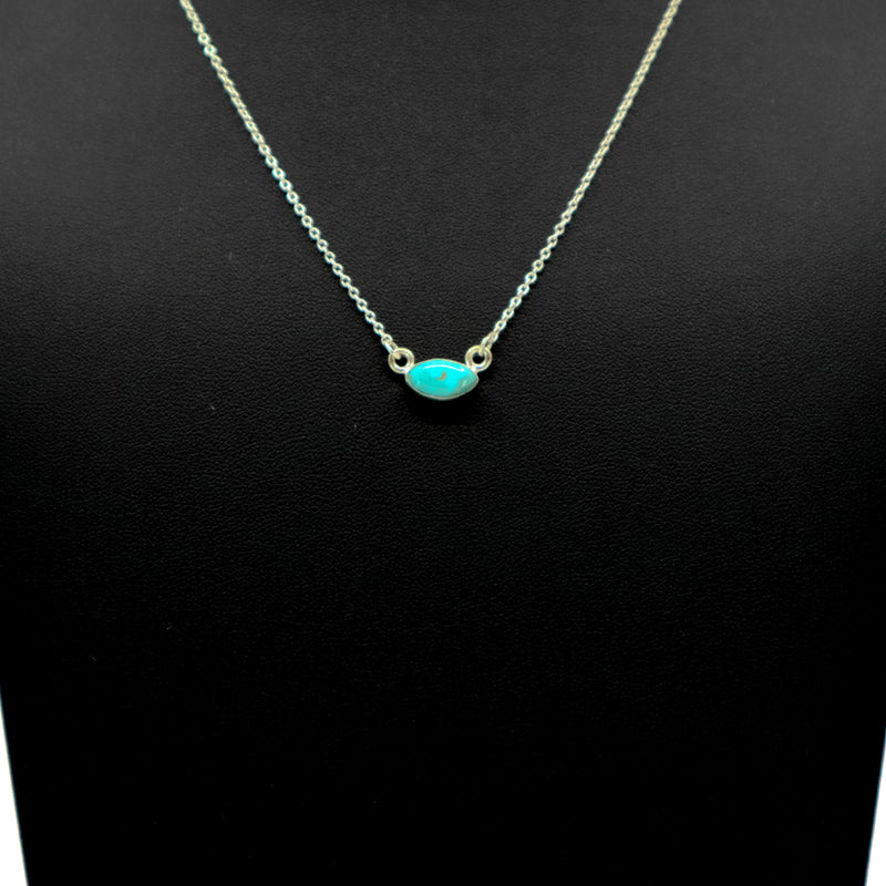 Handmade sterling silver necklace with oval turquoise pendant on black background