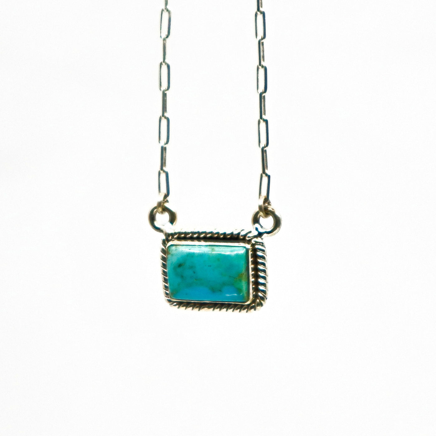 Handmade woven border sterling silver necklace with small turquoise bar pendant