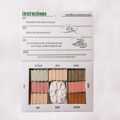 Wood incense bricks sampler with holder featuring seven natural scents.