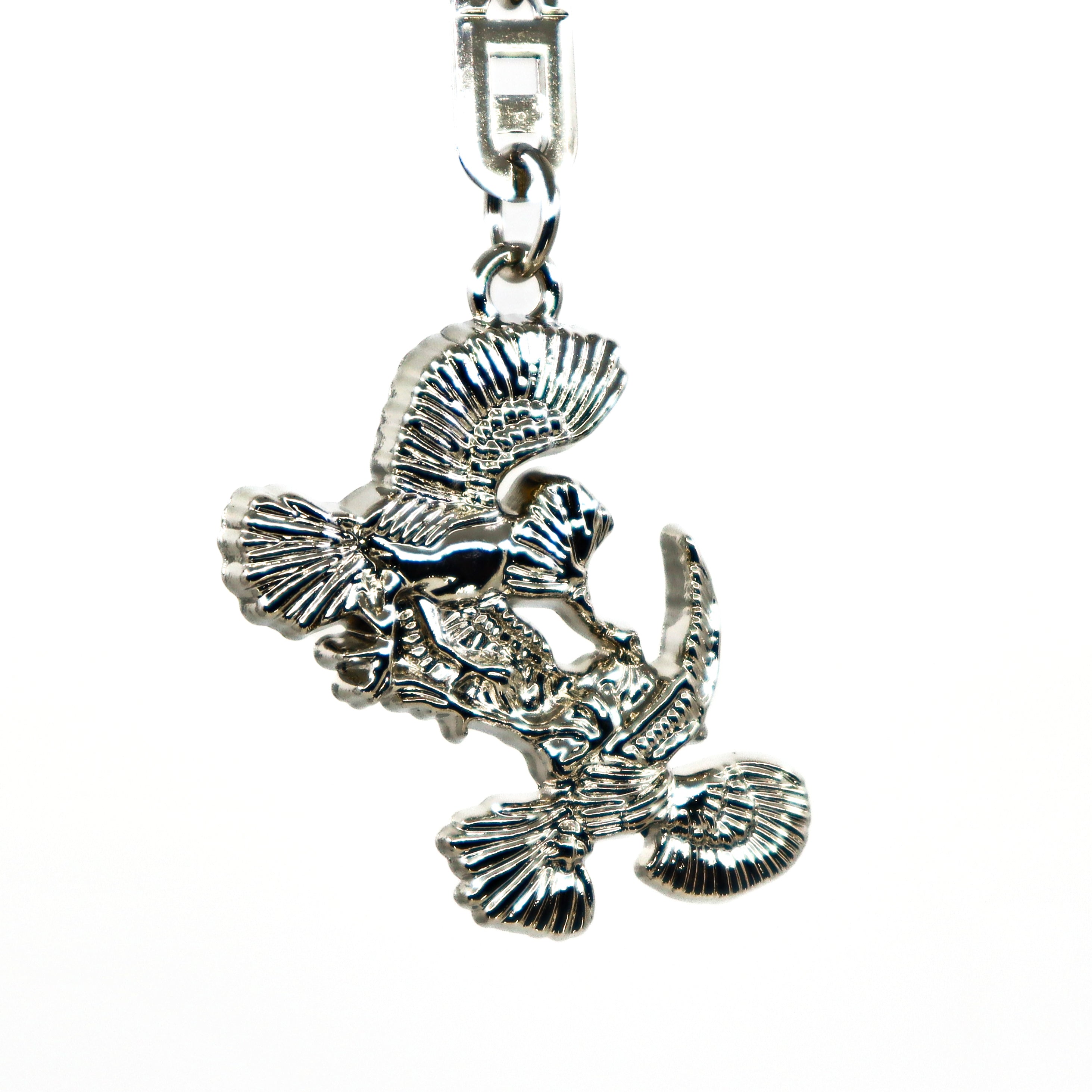 Silver metallic Thunderbird design key ring with intricate feather details and a sturdy clasp.