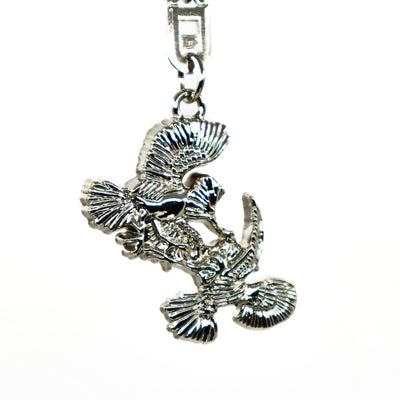 Silver metallic Thunderbird design key ring with intricate feather details and a sturdy clasp.