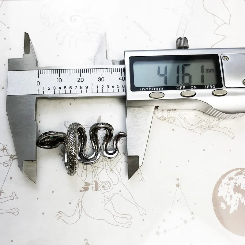 Silver and blue snake-shaped ring measured with digital caliper showing 41.61 mm length