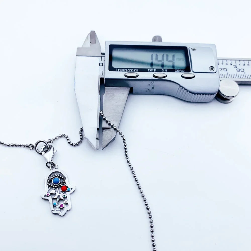 Sterling silver charm necklace with zircon gemstone and symbolic pendant measured at 14.4 cm.