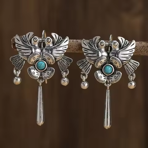 Vintage styled turquoise stone earrings with bird and flower design, bohemian retro vibe.