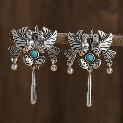 Vintage styled turquoise stone earrings with bird and flower design, bohemian retro vibe.