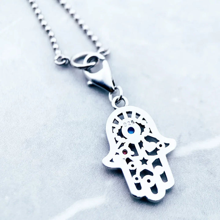 Sterling Silver Charm Necklace with zircon gemstone on a delicate chain.