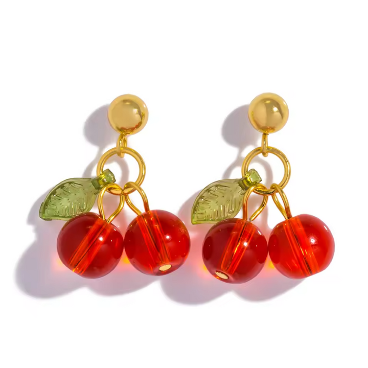 Gold cherry drop earrings with red cherry charms, green leaves, and 18K gold-plated stainless steel studs