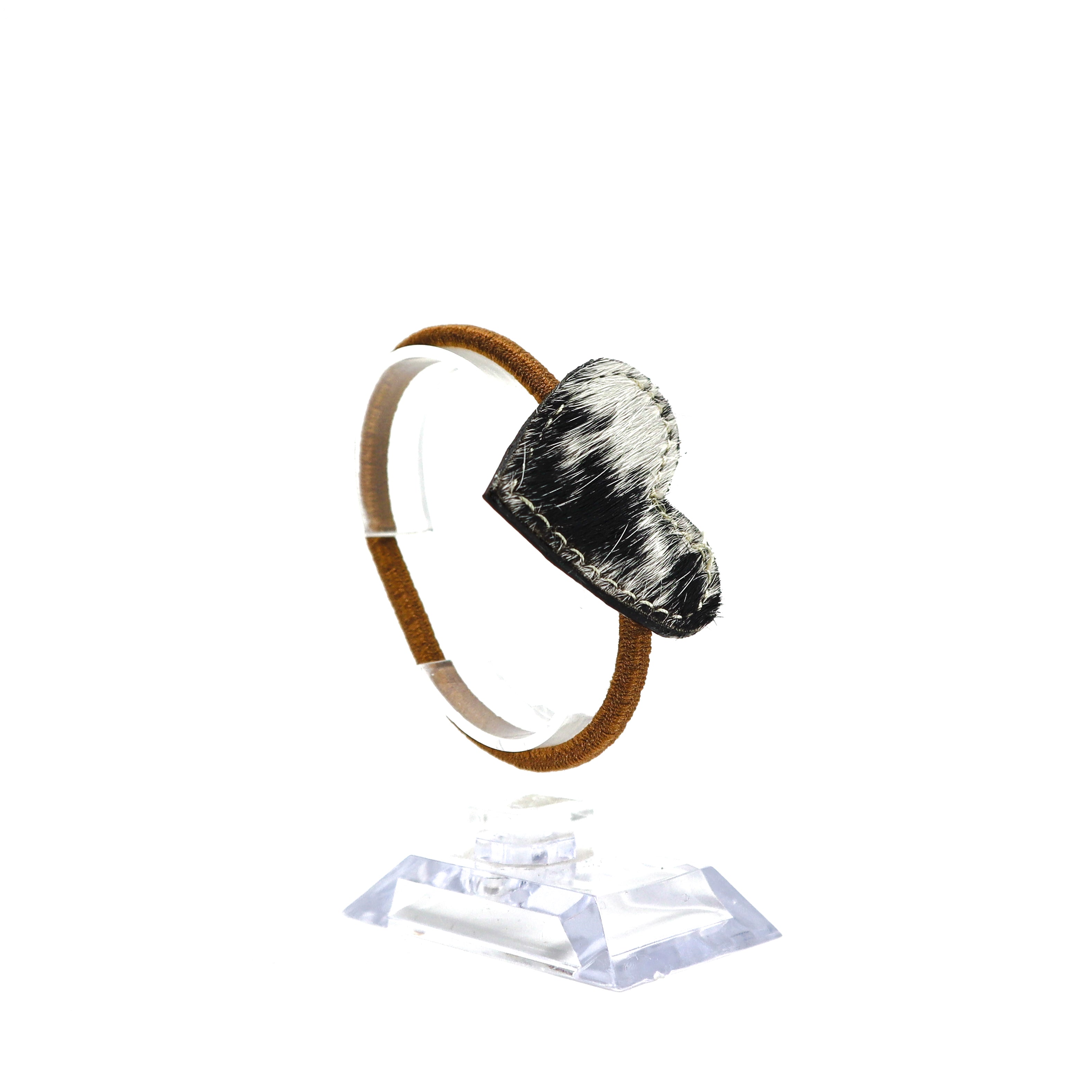 Handmade cow hide leather heart-shaped ponytail holder on clear display stand