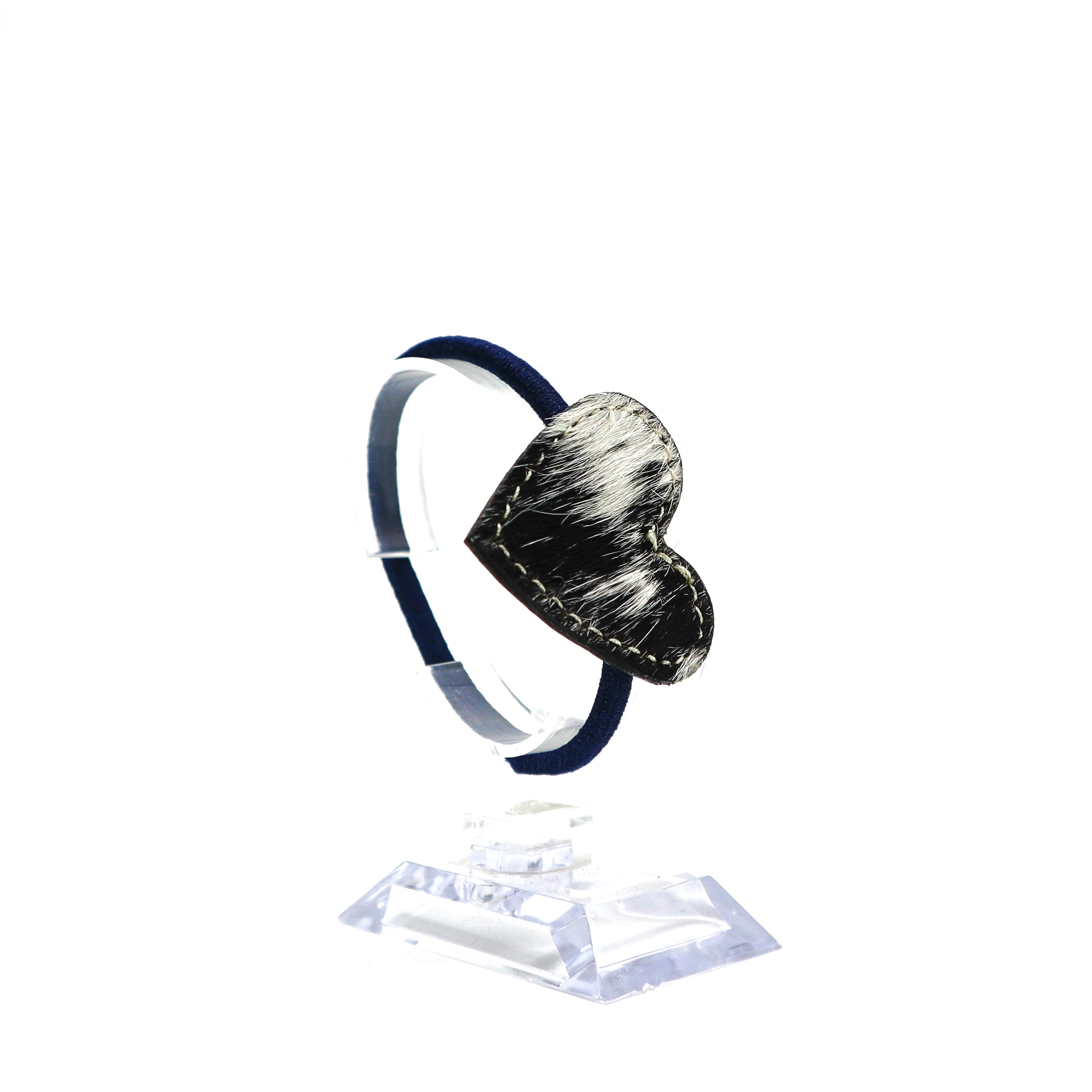 Handmade cow hide leather heart-shaped ponytail holder on clear display stand