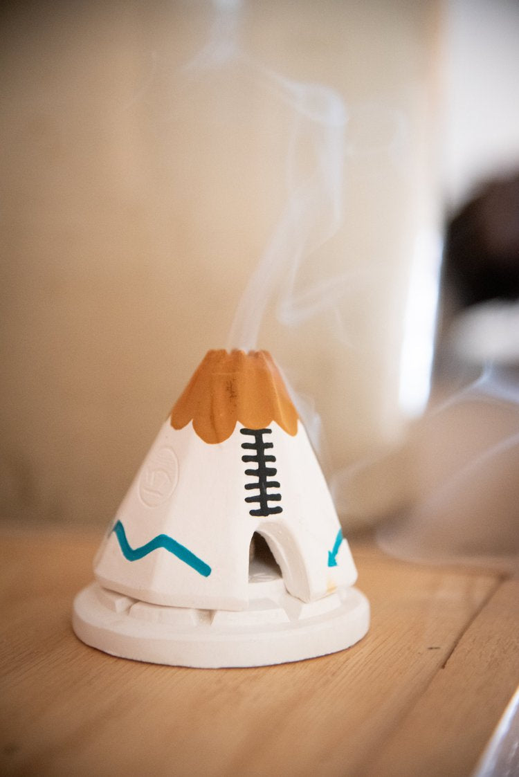 handcrafted teepee incense burner with piñon incense emitting aromatic smoke