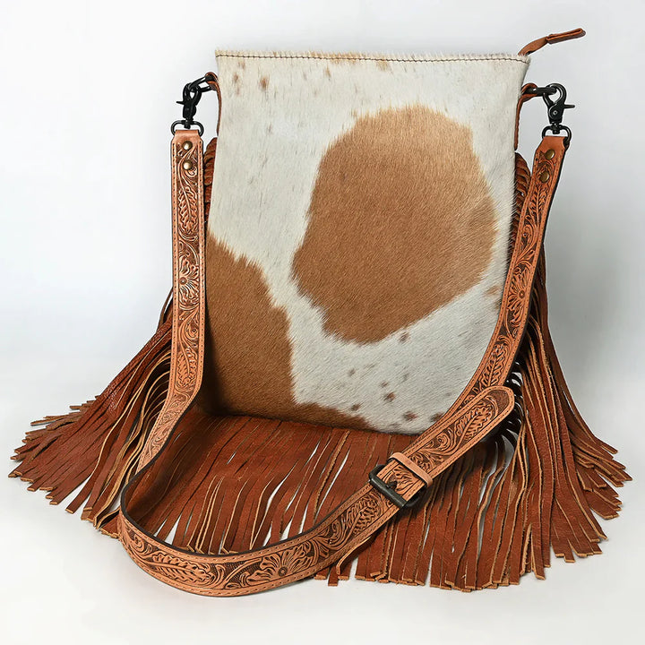 American Darling messenger bag ADBGS192TAW with hair-on cowhide, fringed full grain leather, adjustable tooled cowhide strap, and durable zipper closures