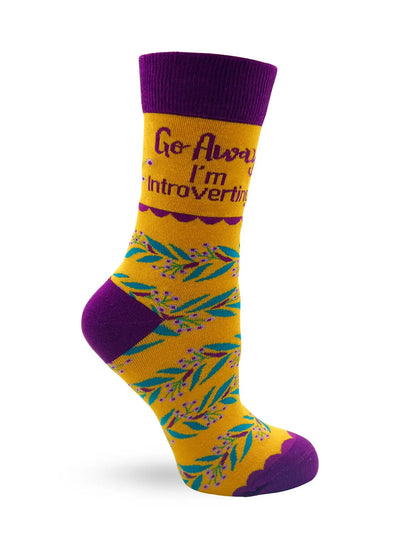 Go Away I'm Introverting women's novelty crew socks in yellow and purple with floral design and statement text