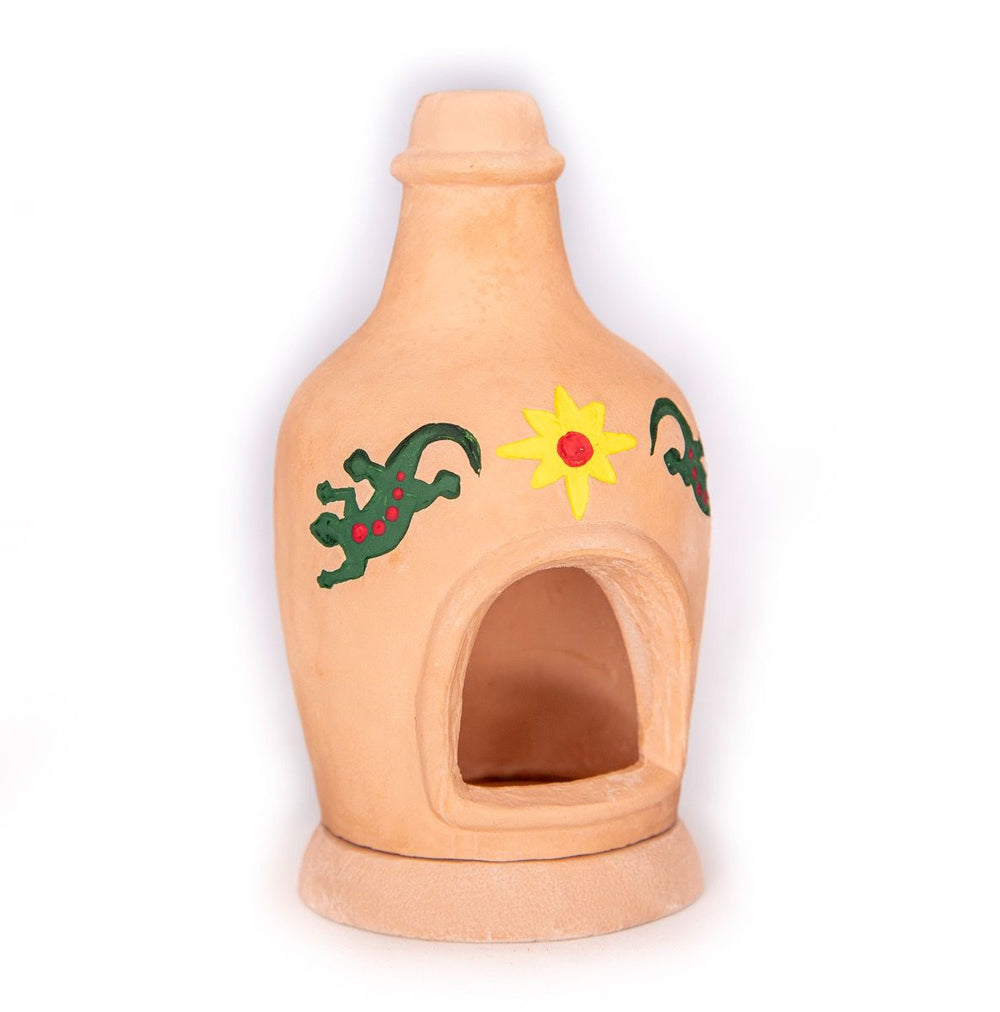 Terracotta chiminea fireplace with colorful lizard and sun designs for indoor or outdoor use.