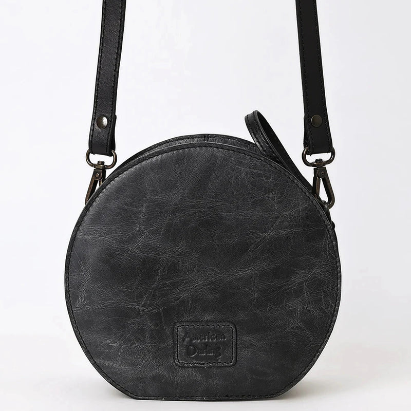 Round black American Darling Canteen Bag made of full grain cowhide leather with adjustable strap and durable zipper closure