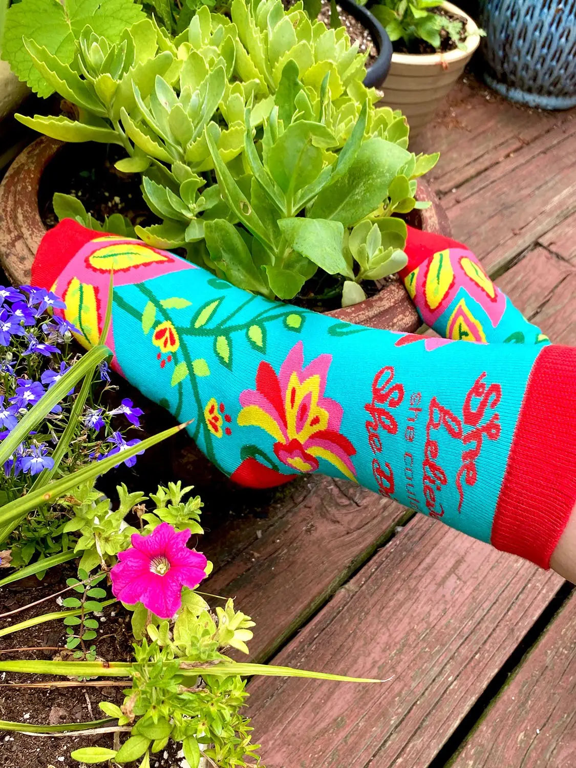 Colorful women's crew socks with floral design and "She Believed She Could" inspirational text, perfect for empowering go-getters.