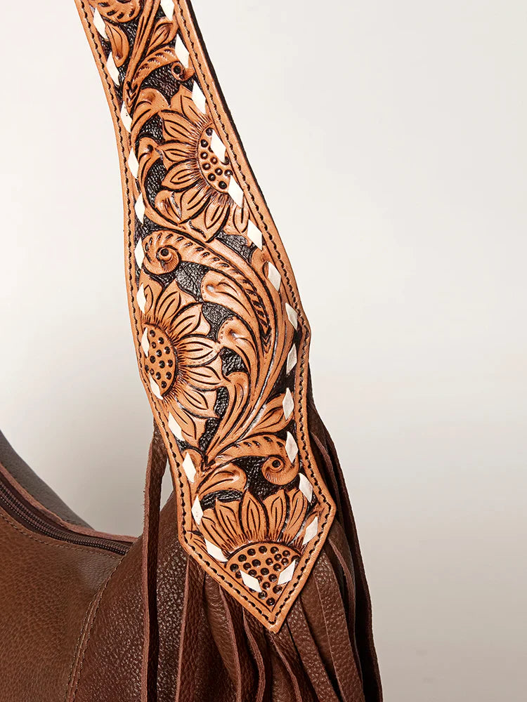 American Darling Hobo bag with genuine leather and hand-tooled strap detail, featuring fringes and durable YKK zipper.