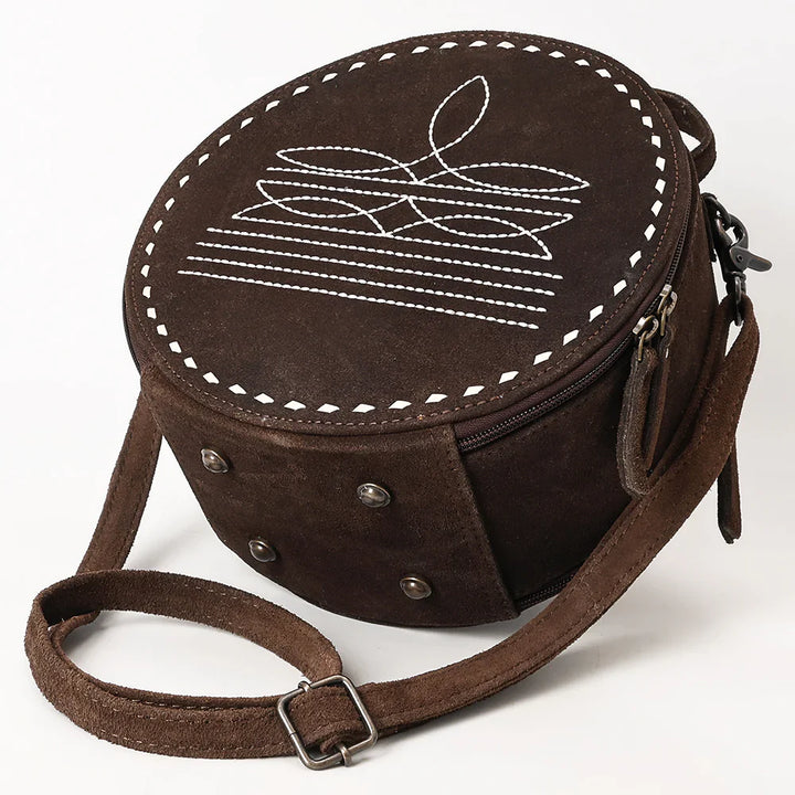 American Darling Canteen Bag made of suede and full grain leather with adjustable strap and antique metal fittings.