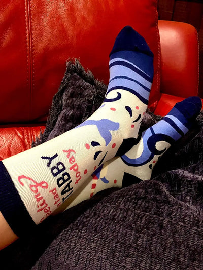Narwhal women's crew socks with moody narwhal design and humorous "Feeling A Tad Stabby Today" text, comfortable fit.
