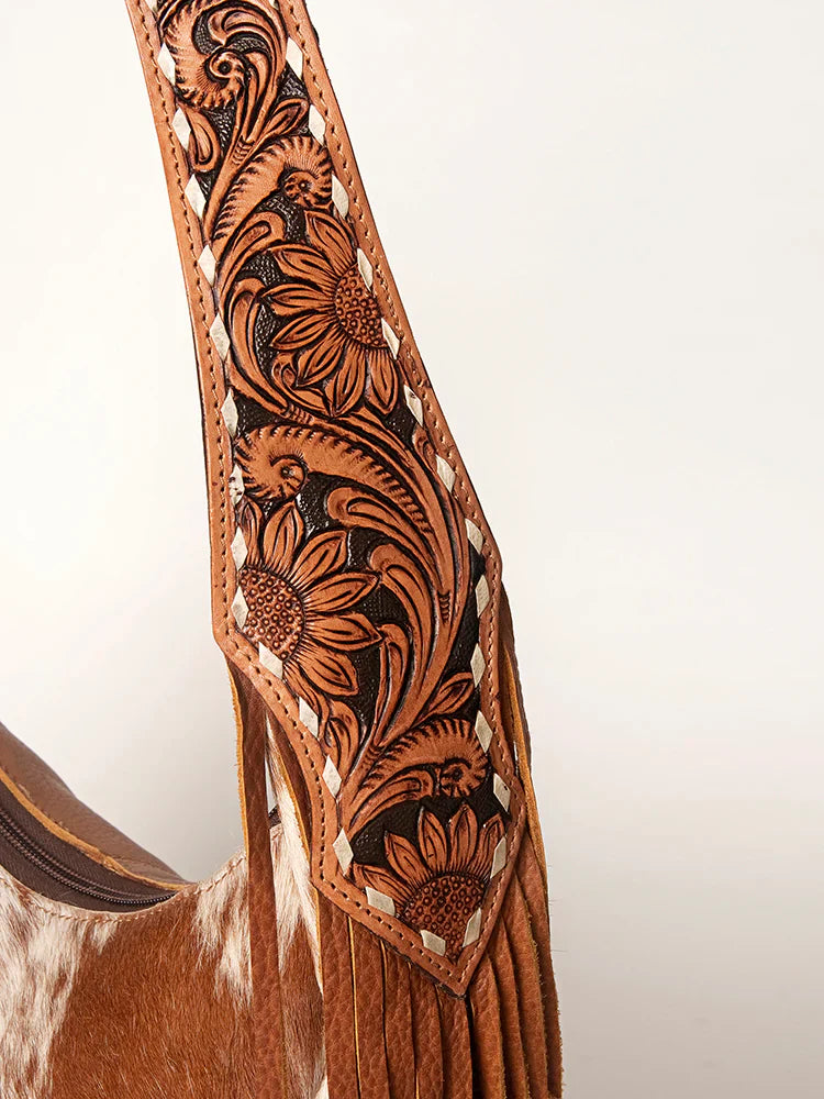 American Darling Hobo bag with cowhide leather, fringes, and hand-tooled strap.