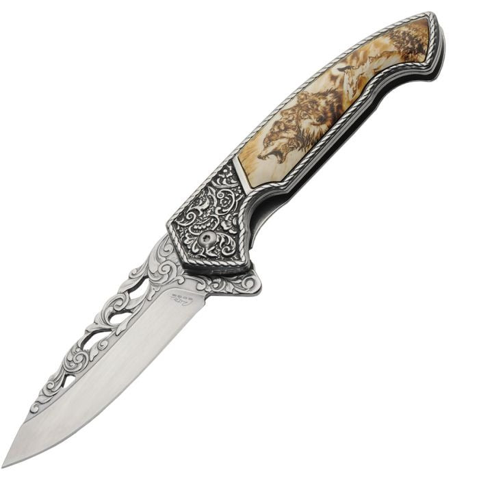 Framelock knife with detailed wolf design handle in a decorative wooden box